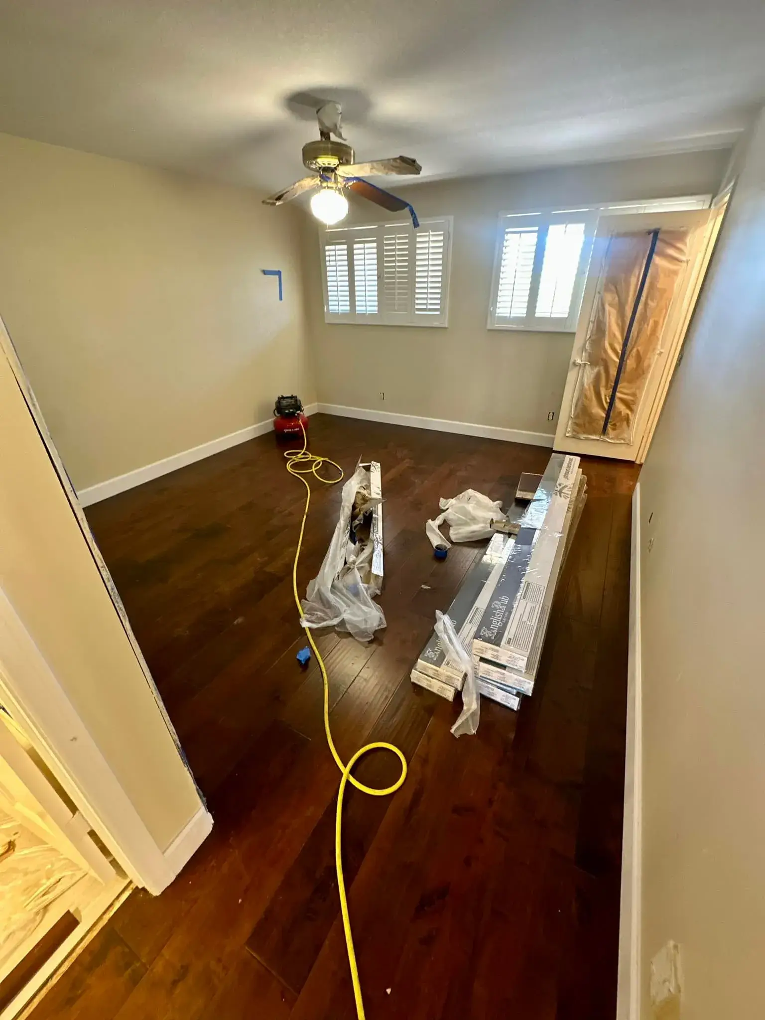 Newly installed dark-stained hardwood plank flooring spanning an Arizona bedroom by Zona Floors